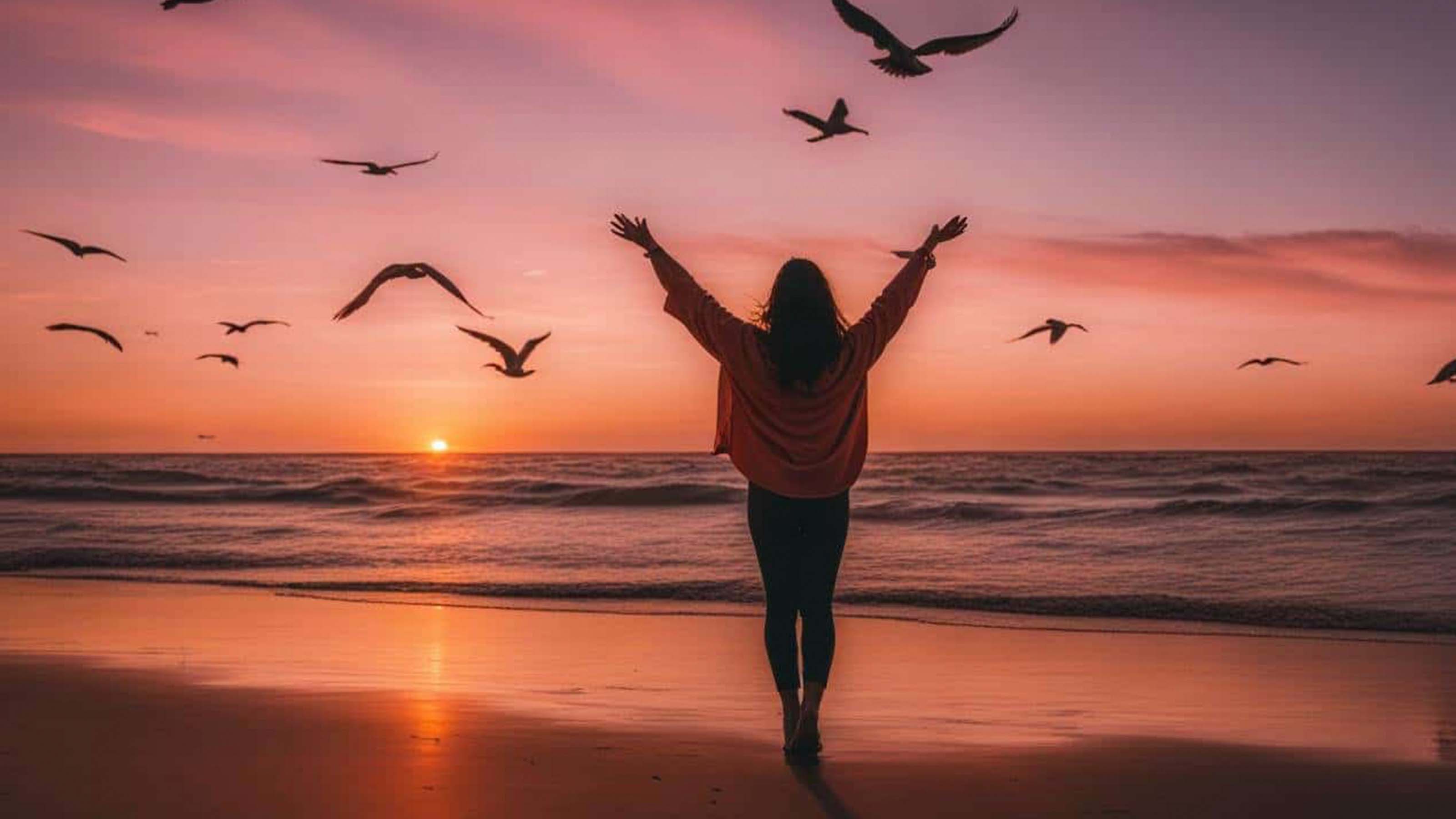 Self Love Collection - Woman walking on beach at sunset