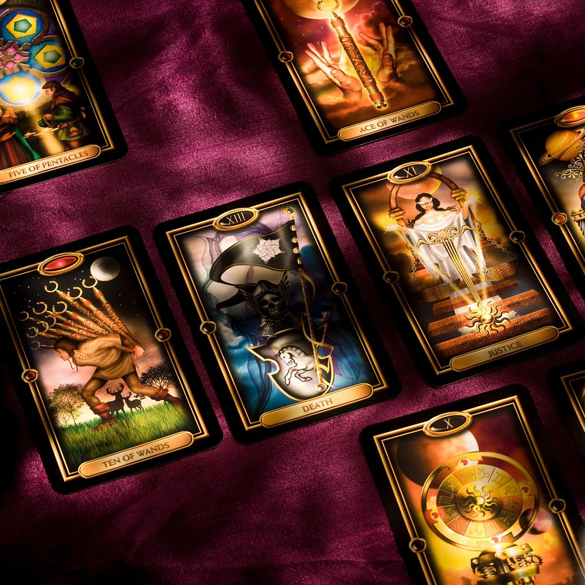 Collection of tarot cards on a purple fabric background